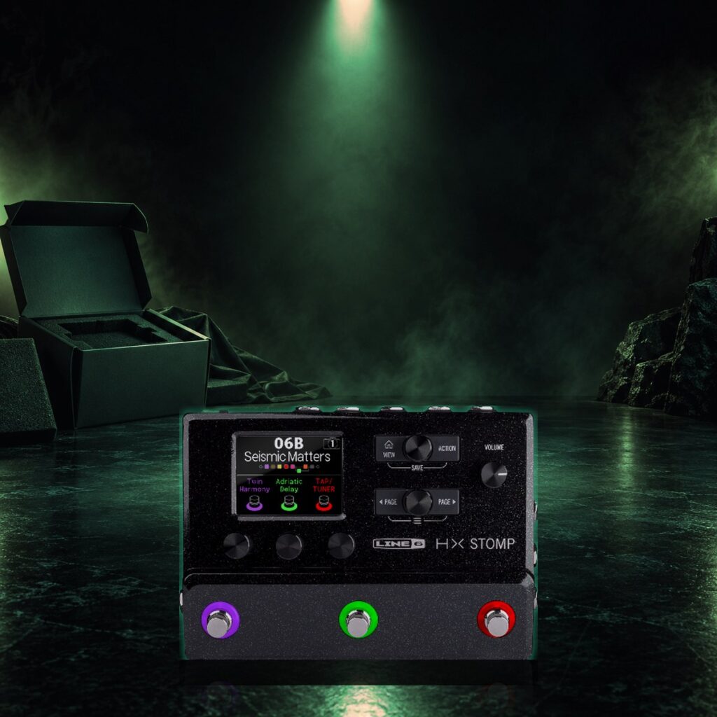New compact multi-effects pedal resting in its open box under an orange spotlight