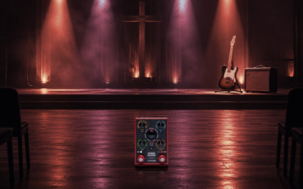 A POD Express on the floor of a small church stage with beams of light through haze